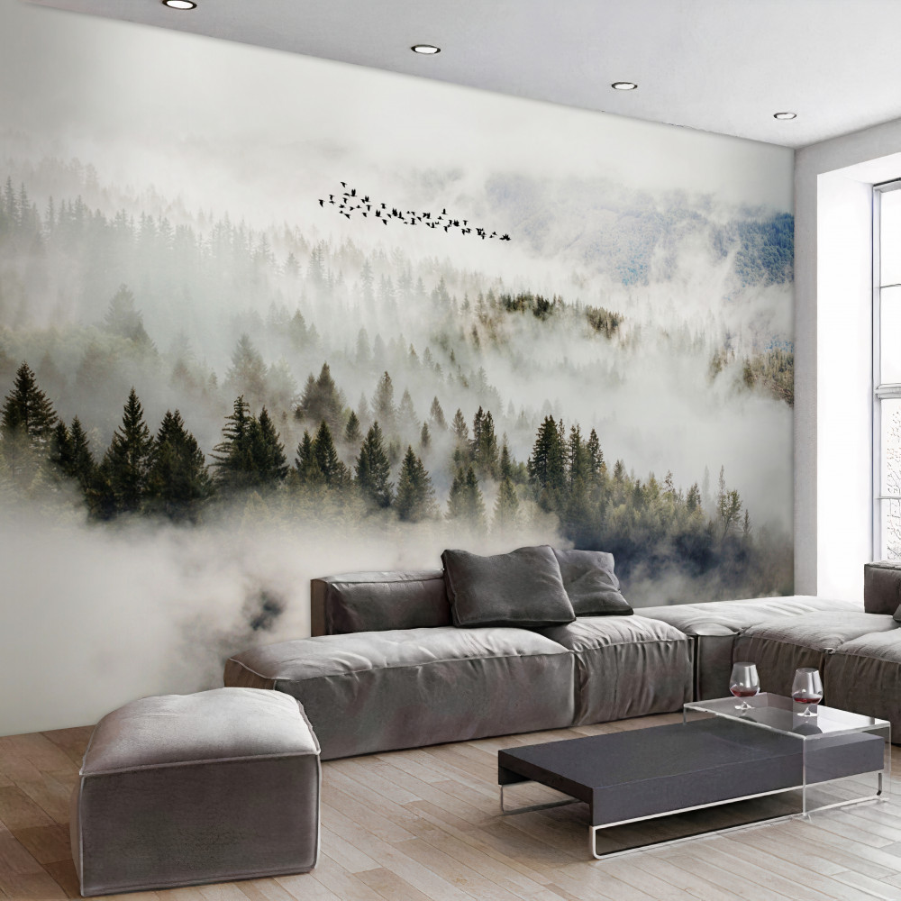 Fototapeta stado ptaków nad mglistym górskim lasem