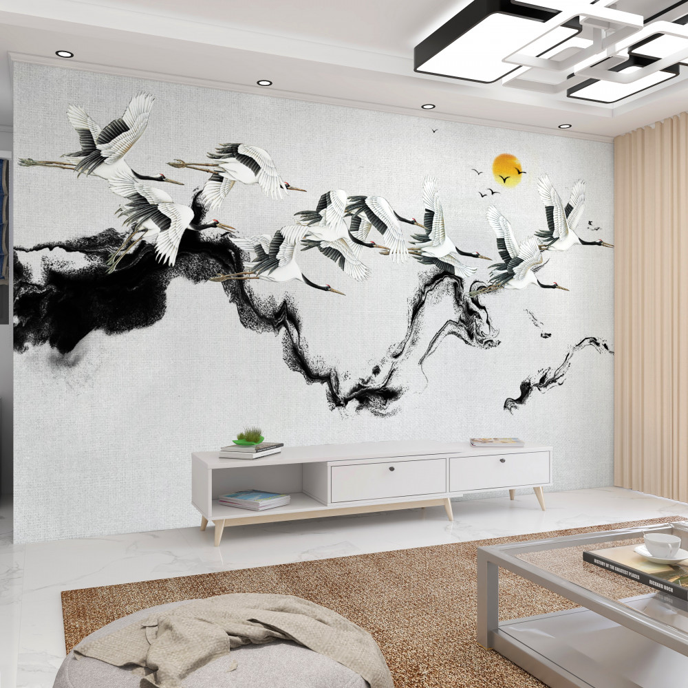 Fototapeta stado żurawi czerwonokoronowanych leci w stronę zachodzącego słońca