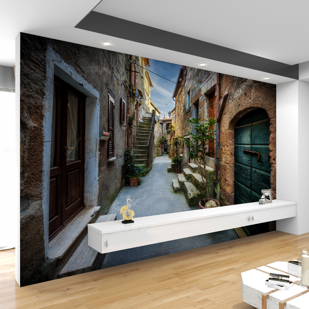 Fototapeta stara kamienna ulica o zachodzie słońca