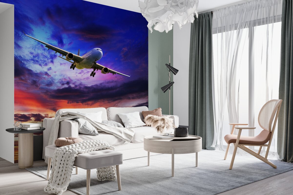 Fototapeta latający samolot na tle zachodzącego słońca nieba