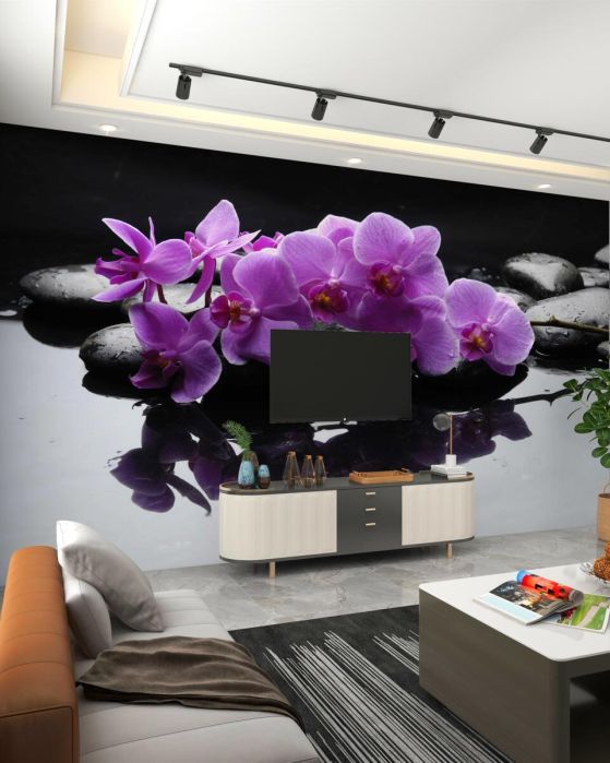 Fototapeta liliowe orchidee w pobliżu wody na kamieniu