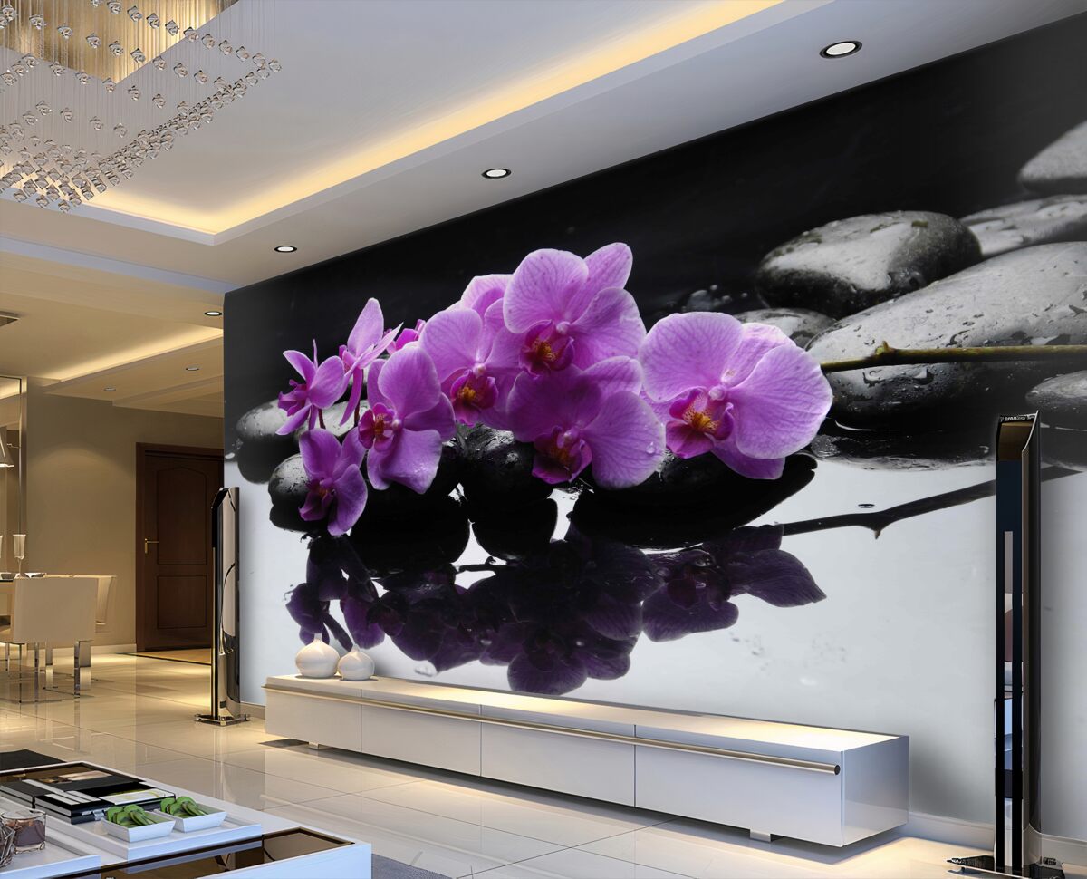 Fototapeta liliowe orchidee w pobliżu wody na kamieniu
